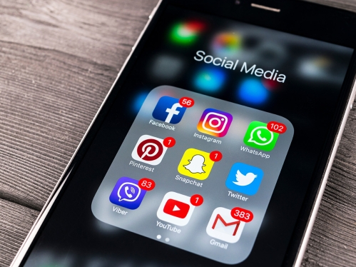 Mobile phone listing several social media icons